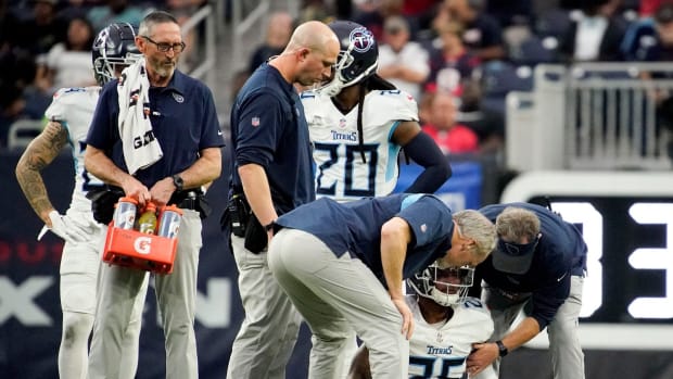 Trainers check on Tennessee Titans cornerback Kristian Fulton (26) after he was injured on a play during the fourth quarter at NRG Stadium Sunday, Jan. 9, 2022 in Houston, Texas.
